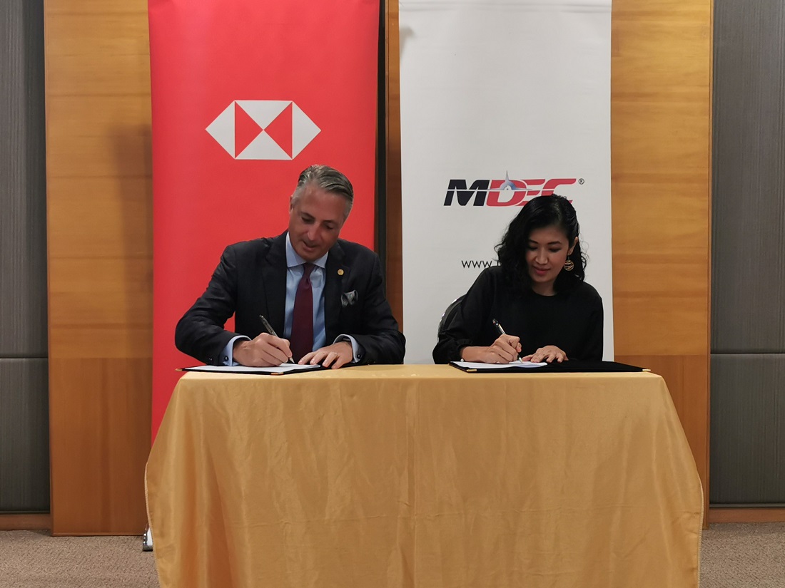 STUART MILNE (left) and Surina Shukri (right) at the signing ceremony to establish the first MoU between HSBC Malaysia and MDEC focused on accelerating the adoption of technology among SMEs, large local corporates and multinational companies in Malaysia. 