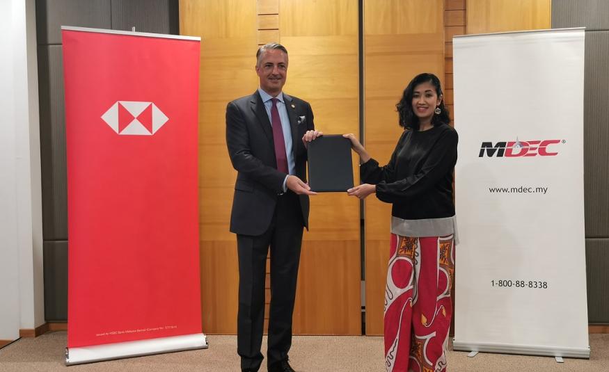 STUART MILNE (left) and Surina Shukri (right) at the signing ceremony to establish the first MoU between HSBC Malaysia and MDEC focused on accelerating the adoption of technology among SMEs, large local corporates and multinational companies in Malaysia. 